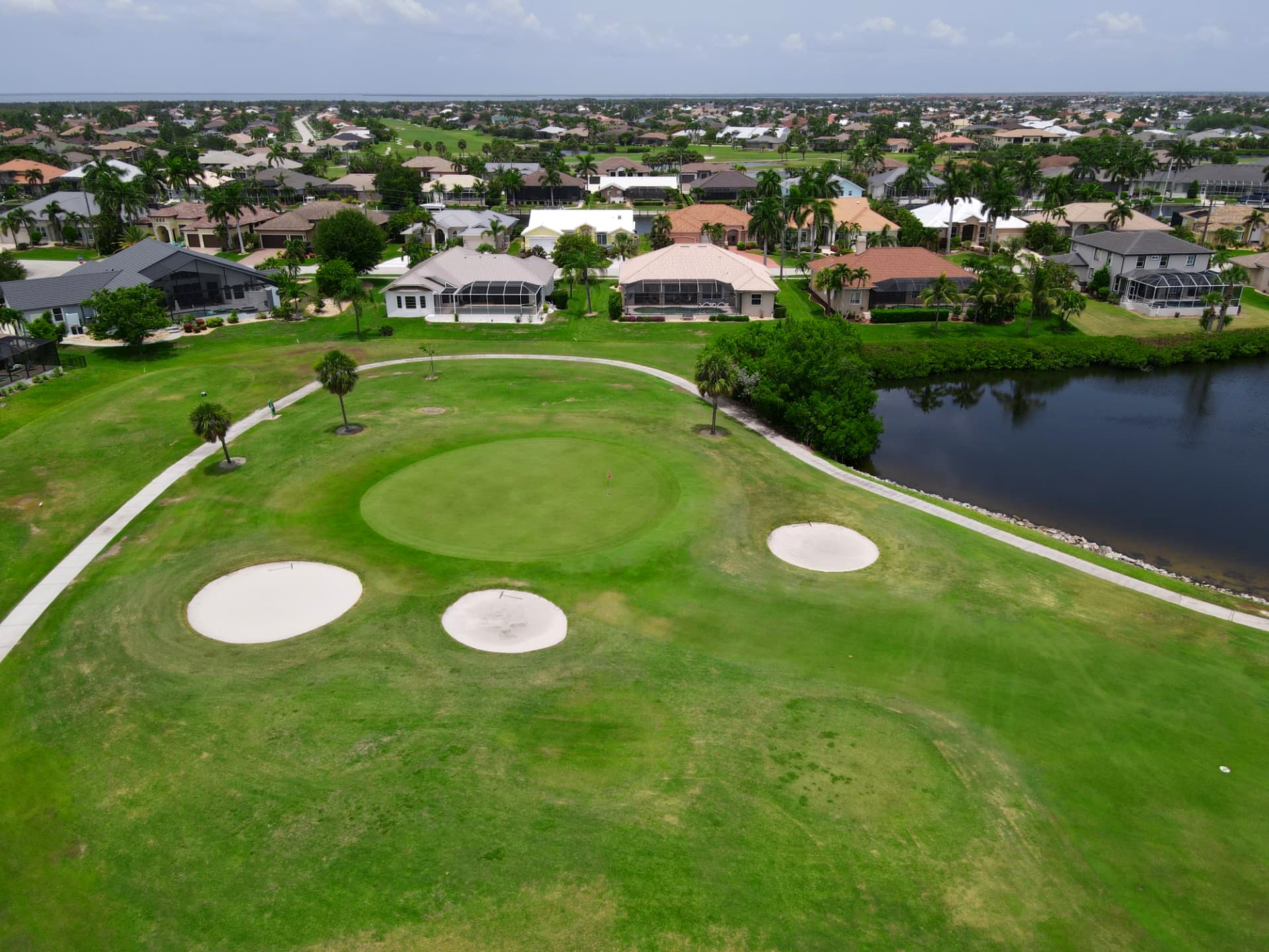 Elevated green protected by three round bunkers