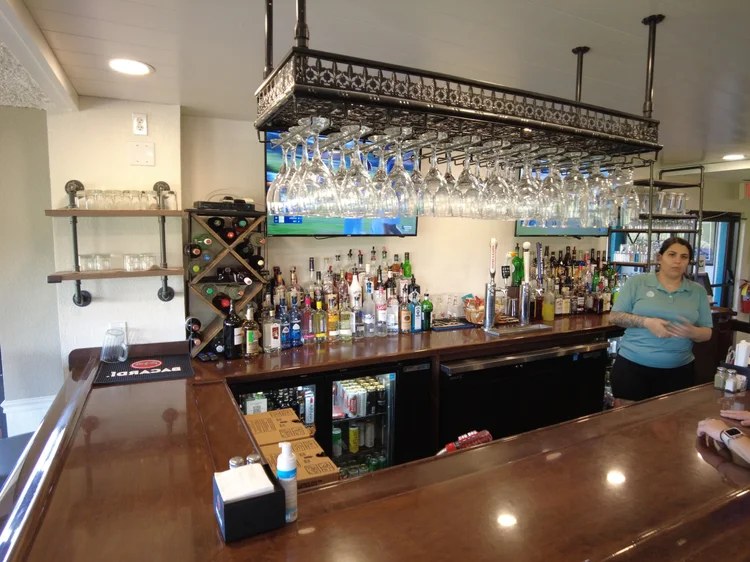 The clubhouse bar with hanging stemware and full liquor selection