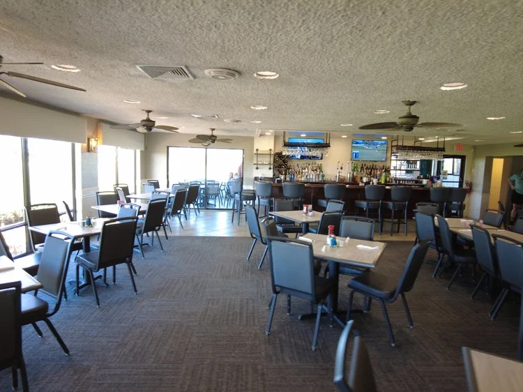 Clubhouse dining room with window seating and the bar beyond