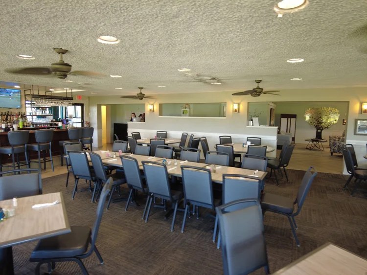 Banquet-style seating arranged in the clubhouse dining room